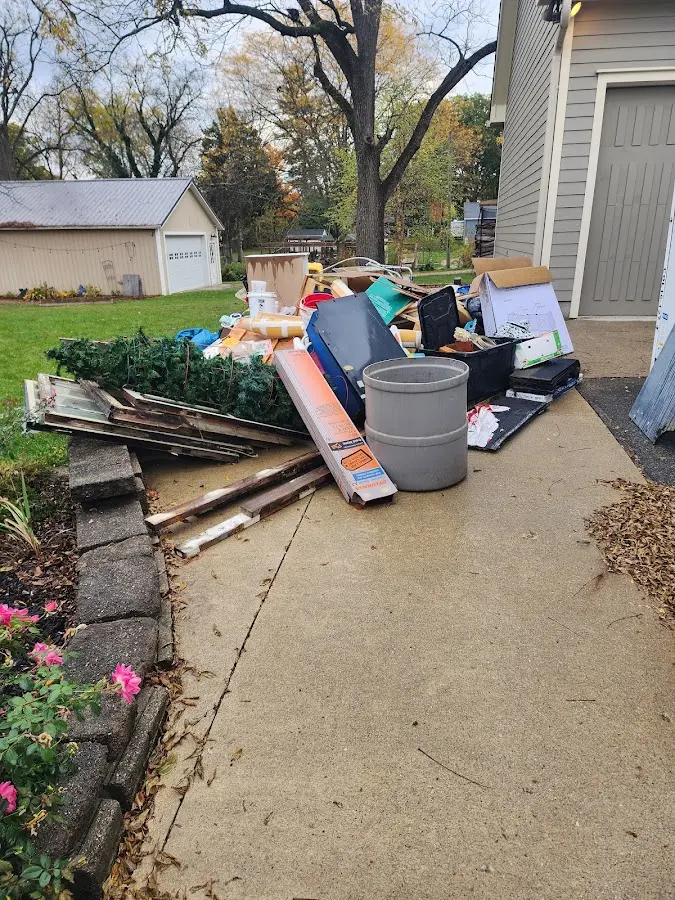 Dumpster being loaded with debris for Estate Cleanout Dumpster Rental in Meridian